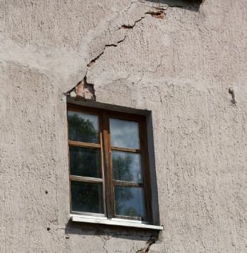 Fachada con una grieta sobre el dintel de una ventana y revoco desprendido: reparación de dinteles